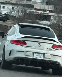 a white mercedes with a license plate that says nyc35