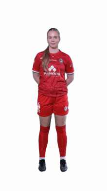 a female soccer player wearing a red shirt with the number 4