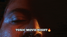 a poster for a toxic movie night with a boat in the ocean