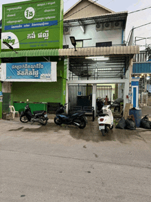 scooters are parked in front of a building with a sign that says ' king '