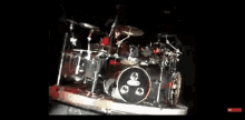 a drum set on a stage with a drummer playing it .