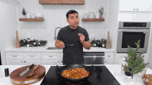 a man in a black shirt is stirring a pan of food with a spoon in a kitchen made in animatica