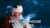 santa claus is blowing snow in the air with the words from our house to yours below him