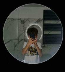 a person taking a picture of themselves in a mirror with a circle around them