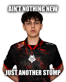 a young man wearing a red bull shirt stands with his hands on his hips