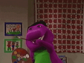 a purple cartoon character holding a palette and a rainbow