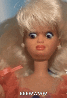 a close up of a barbie doll with a big eye