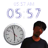 a man with glasses stands in front of a clock that says 05 57 am