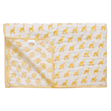 a yellow and white blanket with giraffes and leaves on it