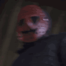 a blurry picture of a man wearing a mask .