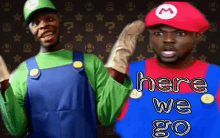 a man in a mario costume is standing next to a man in a luigi costume