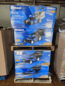 two kobalt lawn mower boxes stacked on top of each other on a wooden pallet