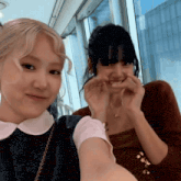 two women are posing for a picture and one of them is making a face