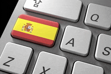 a keyboard with a spanish flag on the a key