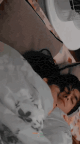 a man and a woman are sleeping in a bed together