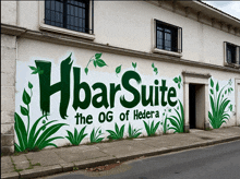 a white building with a green and white sign that says hbarsuite