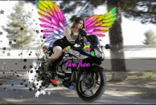 a woman with wings is riding a motorcycle that says live free on it