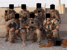 a group of soldiers are posing for a picture with their faces covered