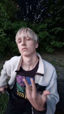 a young man wearing a black t-shirt with smiley faces on it