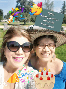 two women are posing for a picture with a birthday card that says feliz cumpleaños querida hermana