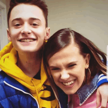 a boy and a girl are posing for a picture and the girl is wearing a pink shirt