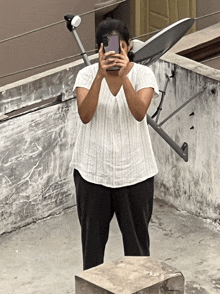 a woman is taking a picture of herself with her cell phone