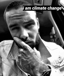 a black and white photo of a man with the words i am climate change above his face