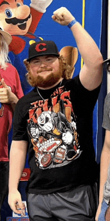 a man with a beard wearing a black t-shirt with a picture of jason voorhees