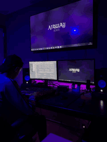 a man sits in front of a computer screen that says airway beats on it