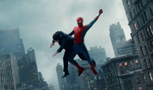 a man in a suit is being held by a spiderman