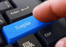 a person pressing a blue sapla key on a keyboard