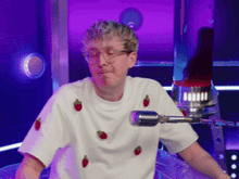 a man wearing a white t-shirt with strawberries on it
