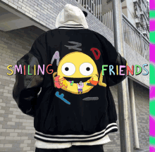 a person is wearing a jacket that says smiling friends