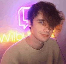 a close up of a person 's face with a neon sign in the background .