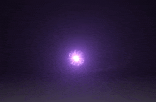 a bright purple light is shining in the dark .