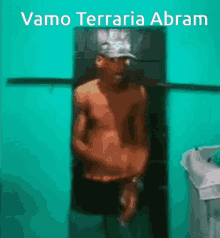 a shirtless man is standing in front of a green wall with the words " vamo terraria abram " above him