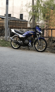 a blue yamaha motorcycle parked on the side of the road