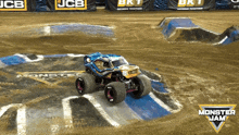 a monster jam truck is driving down a track