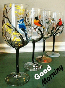 a row of wine glasses with birds painted on them and the words good morning