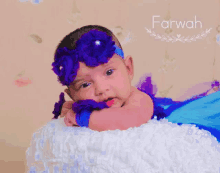 a baby wearing a purple headband with the name farwah written above it