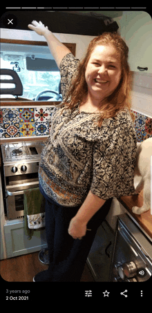 a picture of a woman in a kitchen with the date 2 october 2021