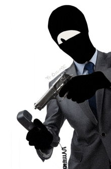 a man in a suit and tie is holding a gun and a phone