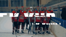 a group of ice hockey players are posing for a photo in front of a banner that says " izmir belediyesi "