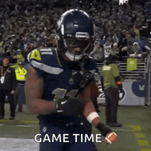 a football player is running with a ball on a field and the words game time are visible .