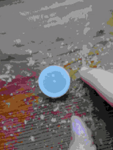 a pixelated image of a blue circle on a table