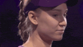 a close up of a woman wearing a purple hat and a purple shirt