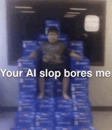 a young boy is sitting on top of a stack of boxes .