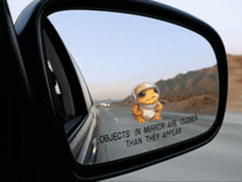 a car rear view mirror has a sticker on it that says objects in mirror are closer than they appear