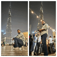 a man squatting down in front of a very tall building with a blue sign on it