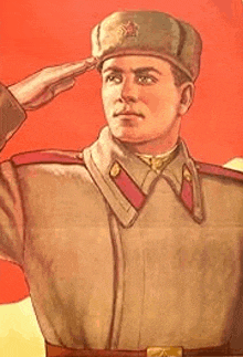 a man in a military uniform saluting in front of a red flag .